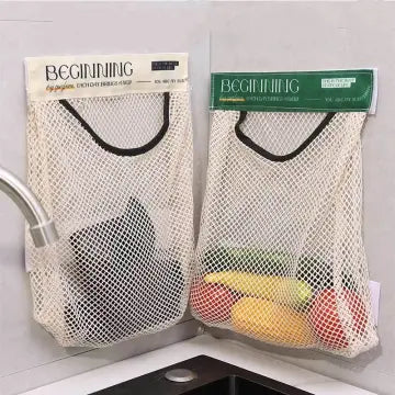 Hand reaching into a mesh bag labeled 'CONVENIENT' attached to a cabinet.