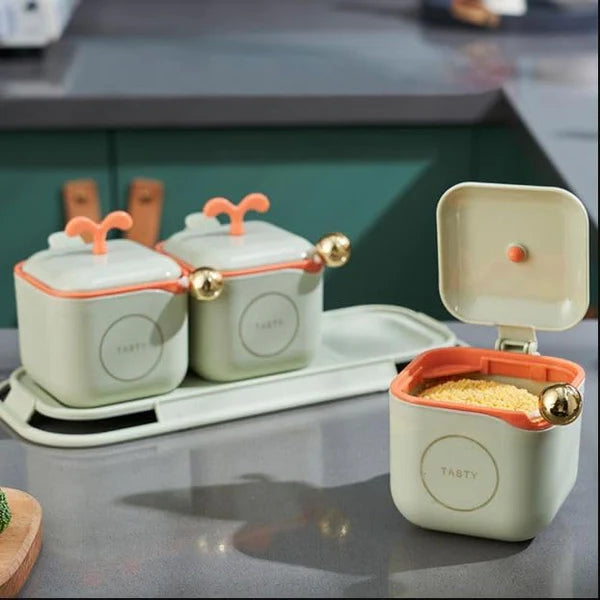Set of ceramic containers with lids on a kitchen counter