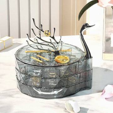 Jewelry organizer with a swan design on a table