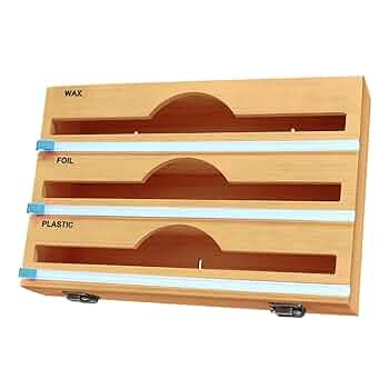 Bamboo cutting board with compartments for plastic, wax paper, and foil on a white background