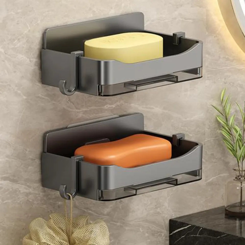 Gray soap holder with a bar of soap on a bathroom counter.